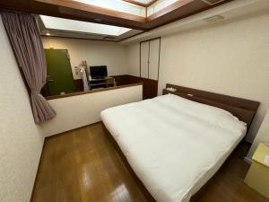 Postel nebo postele na pokoji v ubytování ホテルカスカベ Hotel Kasukabe