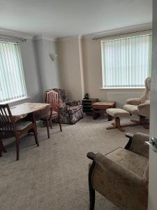 a living room with a table and chairs at Brimsmore Apartment in Yeovil