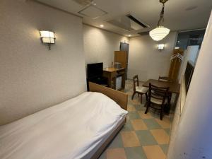 Postel nebo postele na pokoji v ubytování ホテルカスカベ Hotel Kasukabe