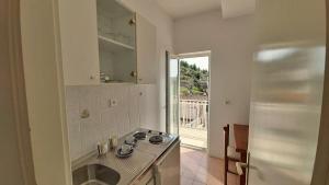 Kuchyň nebo kuchyňský kout v ubytování Apartments Mandalinic