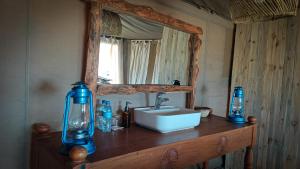 a bathroom with a sink and a mirror at Zawadi Camp in Serengeti