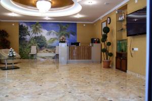 a lobby with a large room with a reception desk at Hotel Exotica in Ureki