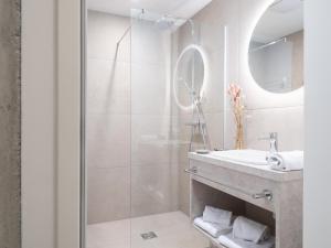 a bathroom with a shower and a sink at BASECAMP Reiteralm in Pichl