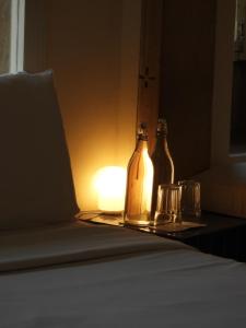 two bottles sitting on a table next to a lamp at The Stepwell Hotel in Jodhpur