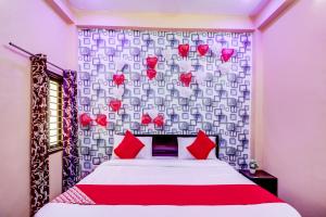 a bedroom with a bed with red hearts on the wall at OYO Flagship Radhey Krishna Bhawan in Bijnaur