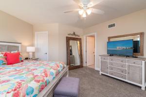 a bedroom with a bed and a flat screen tv at Top floor condo, steps away from JW Marriott and Beach Access!! in Marco Island +20 photos