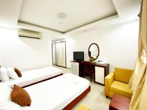 胡志明市的住宿－Cozi 5 Serviced Apartment，酒店客房,设有两张床和镜子