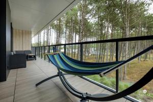 a hammock on the balcony of a house at Shellter Apartments Villas - by Jantar Apartamenty in Rogowo
