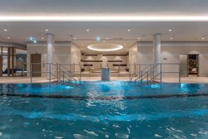 a large pool of water in a hotel lobby at Radisson Blu Hotel & Residences Zakopane in Zakopane