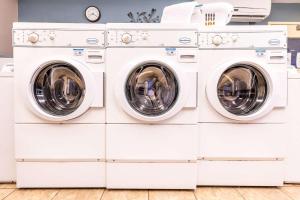 two washing machines stacked up in a laundry room at Sonesta Simply Suites Dallas Galleria in Dallas