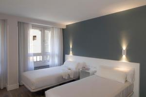 Postel nebo postele na pokoji v ubytování Hotel Gran Regente