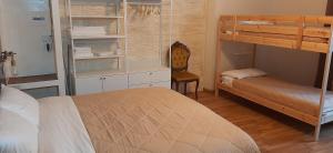 a bedroom with a bunk bed and a desk at Cairóly Rooms' in Termoli