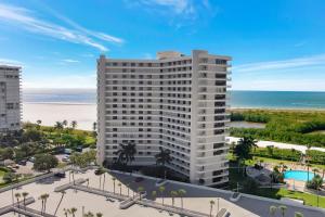 an aerial view of a building with the beach in the background at Elegant beachfront condo in private community in Marco Island