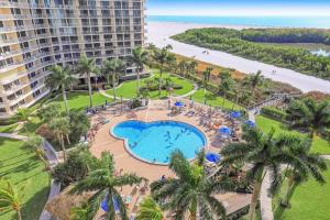 an aerial view of a resort with a swimming pool and the beach at Elegant beachfront condo in private community in Marco Island