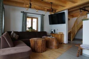 a living room with a couch and a tv at Chalet Bauer in Drachselsried