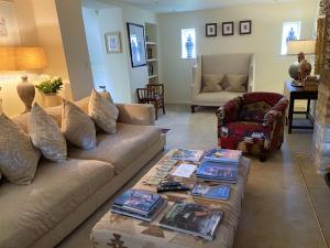 a living room with a couch and a table at Little Campden House in Chipping Campden