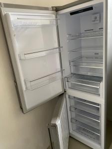 an empty refrigerator with its door open in a kitchen at Apartment Hafingerweg 11/EG in Sankt Pölten