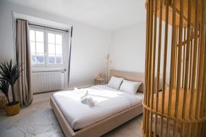 a bedroom with a white bed and a window at Typical Parisian Studio in Le Marais in Paris