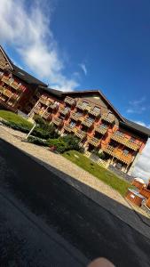 a building with many apartments in front of it at Apartmány Timea B 201 in Veľká Lomnica