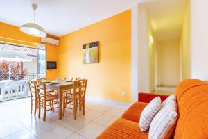 a living room with a couch and a table and chairs at Appartamento Minerva int3 - MyHo Casa in Tortoreto Lido