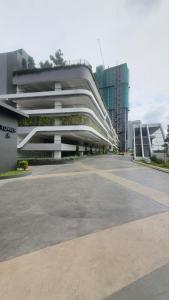 an empty parking lot in front of a building at Sensorizza @ Sensory Residence in Kampong Tangkas