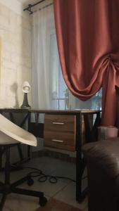 an office with a desk and a chair and a curtain at Vieille Ville 1 - Luca's Apartment, 1 bedroom, max 2 adults and 2 kids in Antibes