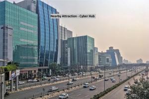 a busy highway in a city with buildings at Super Capital O Tipsyy 006 Near Aravali Biodiversity Park in Gurgaon