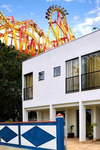 a roller coaster in front of a building at Pousada Estrela de Davi in Penha