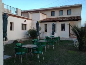 a group of tables and chairs in front of a building at La Simona in Los Cerralbos