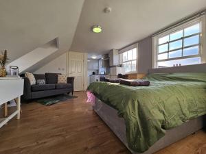 a bedroom with a bed and a living room at Bee Accommodations - Studio in Leicester