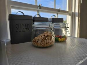 two jars of nuts and fruit on a table at Bee Accommodations - Studio in Leicester