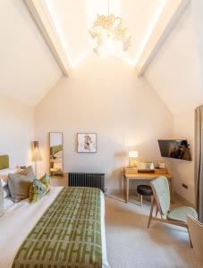 a bedroom with a bed and a desk in a room at The Small House at The Heaning Estate in Windermere