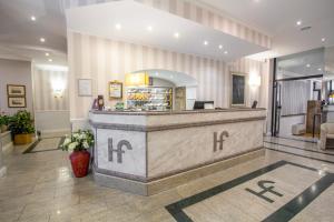 a lobby with a reception desk in a building at Hotel Flora in Milan