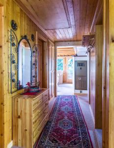 Cette chambre comprend une coiffeuse, un miroir et un tapis. dans l'établissement Chalet Tobeleck - CharmingStay, à Flumserberg