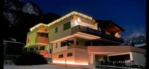 a building with lights on top of it at night at Appartement Mountain Lake in Maurach
