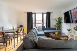 a living room with a couch and a table at The Zenith: Your Urban Oasis in Leicester