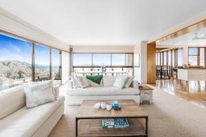 a living room with white furniture and large windows at Montville Resort Style Holiday Retreat with pool in Perwillowen