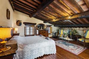 a bedroom with a large bed in a room with wooden ceilings at Casa Teresina in Collodi