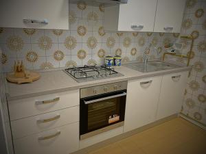 a kitchen with a stove and a sink at Al sit ed Marino in Castel Maggiore