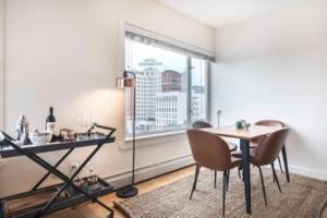 a dining room with a table and chairs and a window at Newly Renovated 3 Bedroom Apartment in New York