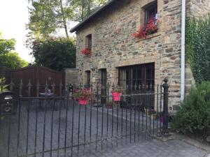 a wrought iron fence in front of a brick building at La Petite maison in Montleban