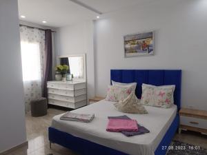 a bedroom with a bed with two towels on it at TIM Haute standing appartment S2, center Monastir in Monastir