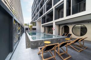 a swimming pool on the roof of a building at Newly Opened - Blu Monkey Hub and Hotel Krabi Town in Krabi town