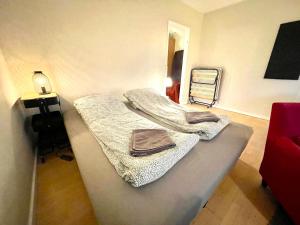a room with two beds with towels on them at Whole Apartment 20 minutes from the city center in Søborg