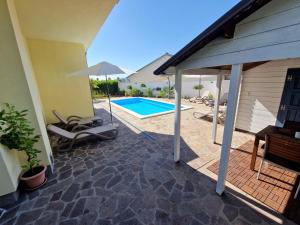 a patio with a swimming pool in a house at House Vertel in Matulji