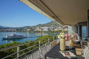 een balkon met een tafel en een boot in het water bij Lake View Montreux Jazz Festival in Montreux
