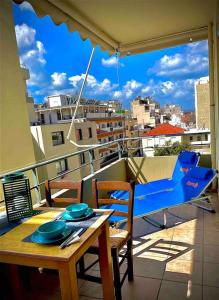a table and chairs on a balcony with a view of a city at Appartement Chania Centrum in Chania Town