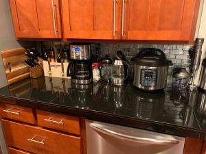 a kitchen counter with a coffee maker on it at Forest & City Views - Near Portland, Nike & Intel in Beaverton