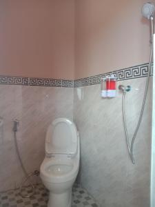 a bathroom with a toilet and a shower at Tarsan Homestay in Labuan Bajo