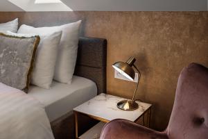 a hotel room with a bed and a table with a lamp at Theatre 9 Apartments by Adrez in Prague